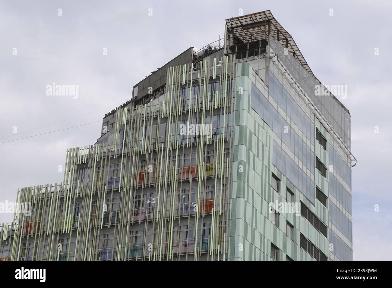 Picture of Facade of figure building with modern architecture in cloudy weather ...