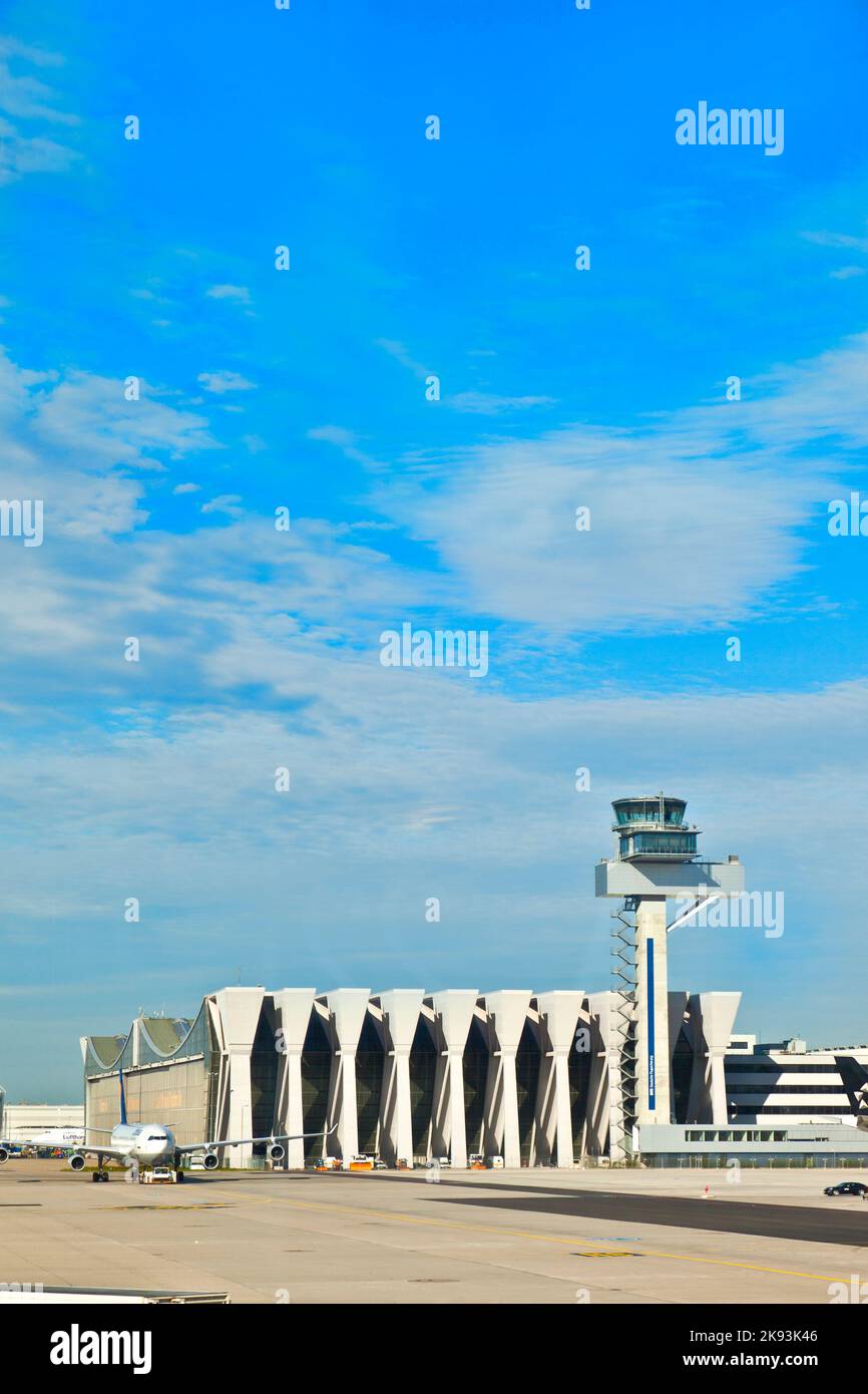 Frankfurt, Germany - August 25, 2010: maintenance hall and the tower of german air traffic control  in Frankfurt, Germany. Frankfurt Airport is the bu Stock Photo