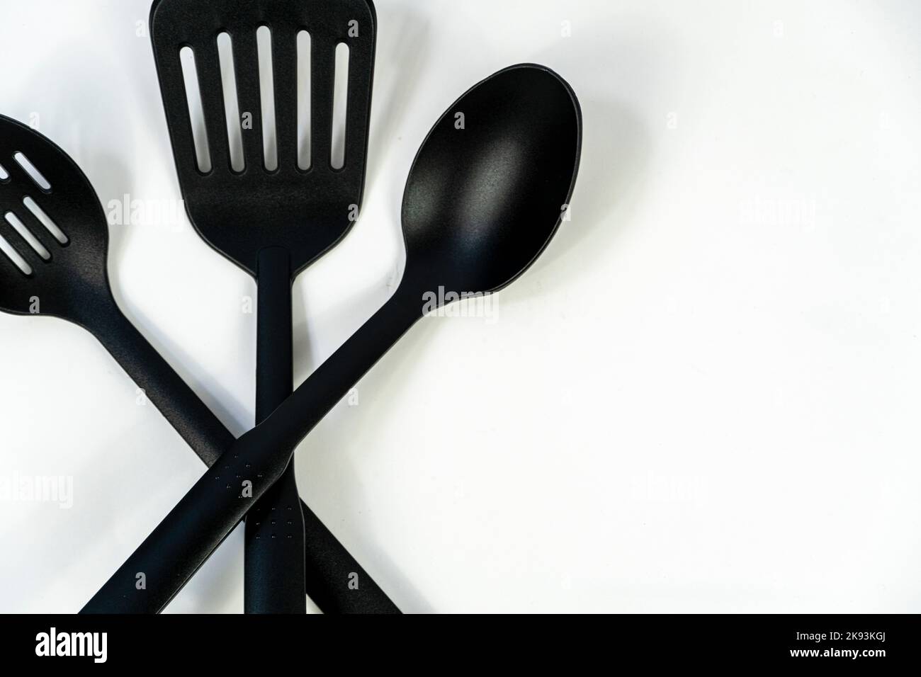 spatulas and spoons black plastic on white background, mexico Stock
