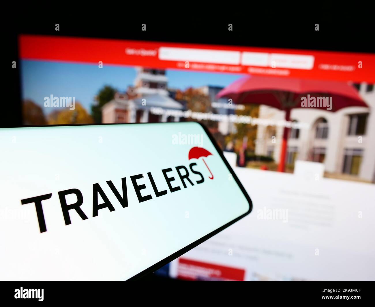 Mobile phone with logo of US insurance company The Travelers Companies Inc. on screen in front of website. Focus on center of phone display. Stock Photo