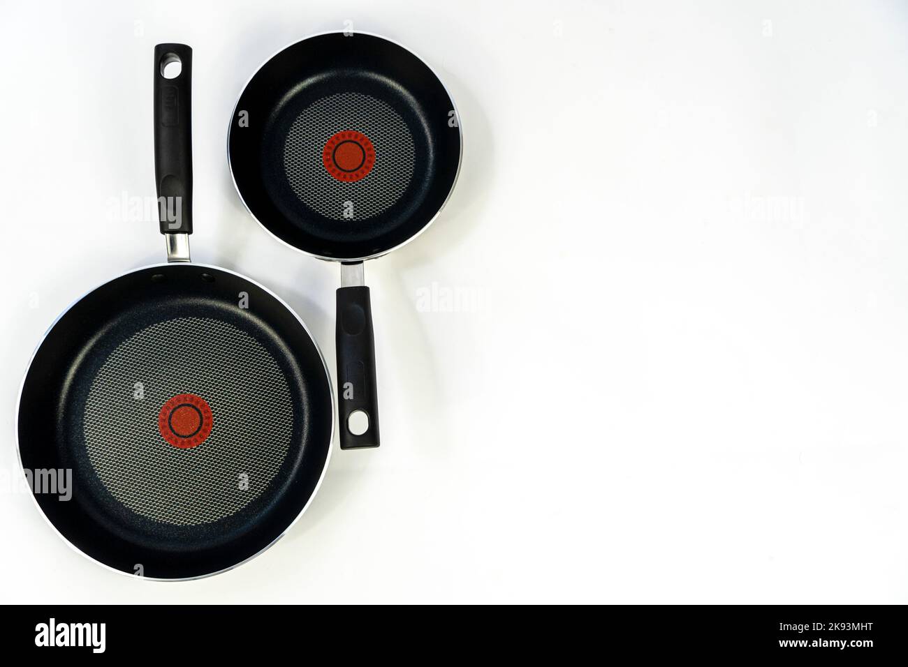 teflon cooking pans, black teflon on white background, plastic handles