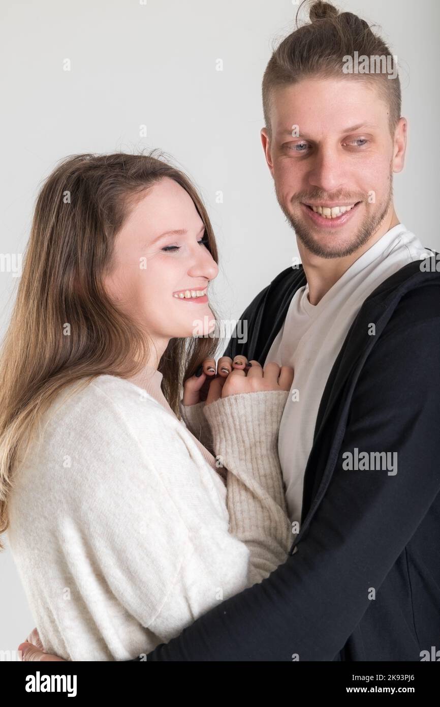 Young blond european couple of lovers close-up vertical portrait on white background Stock Photo