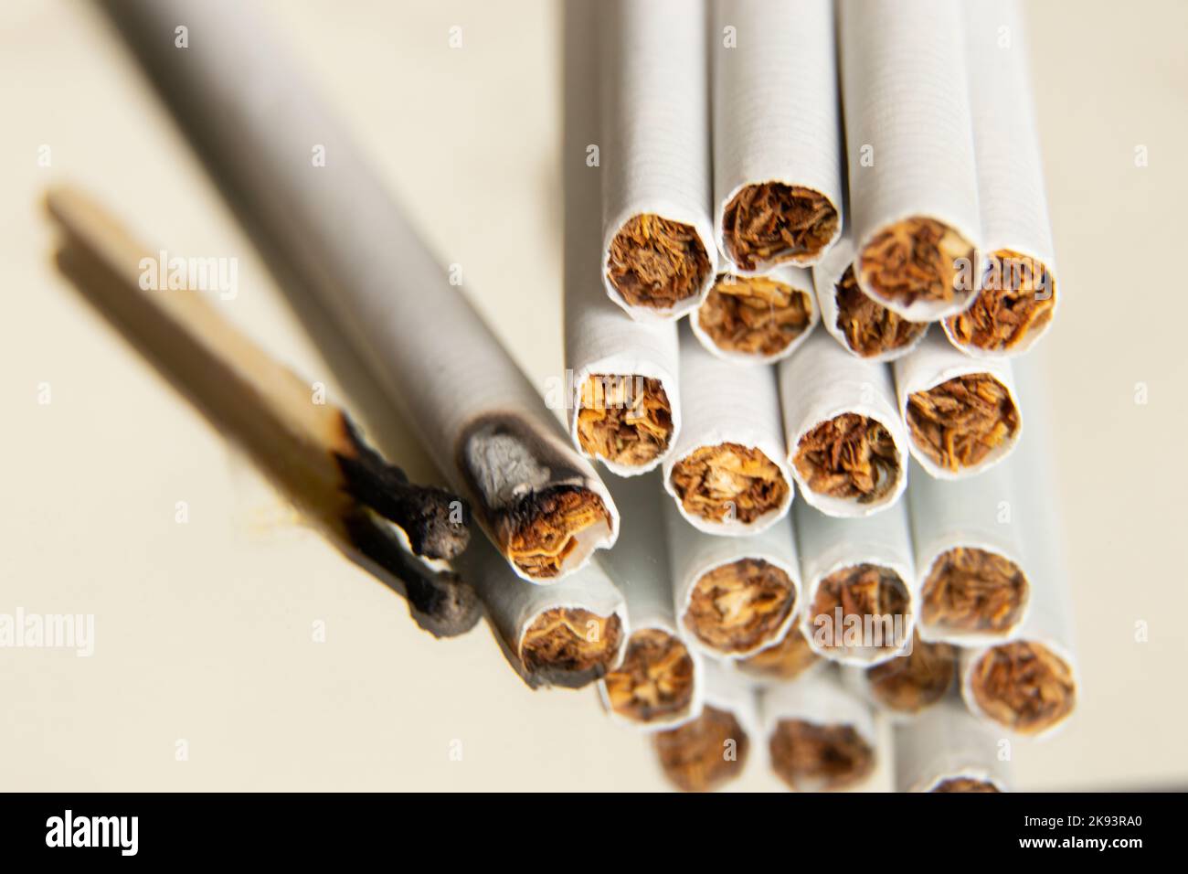 cigarettes and a burnt match on an isolated background, cigarettes and ...