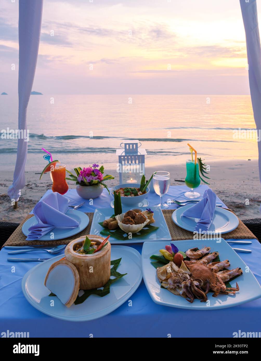 Closeup of the dinner table on the beach during sunset, Romantic