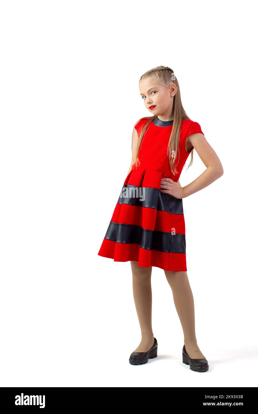 Funny teen girl in a red dress on a white background. Little ...