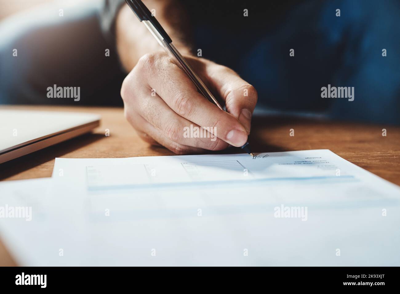 Sealing the deal. an unrecognizable businessman signing paperwork in ...