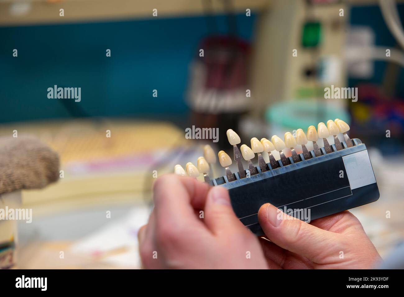 A palette for determining the color of teeth in the hands of a dental orthopedist. Stock Photo