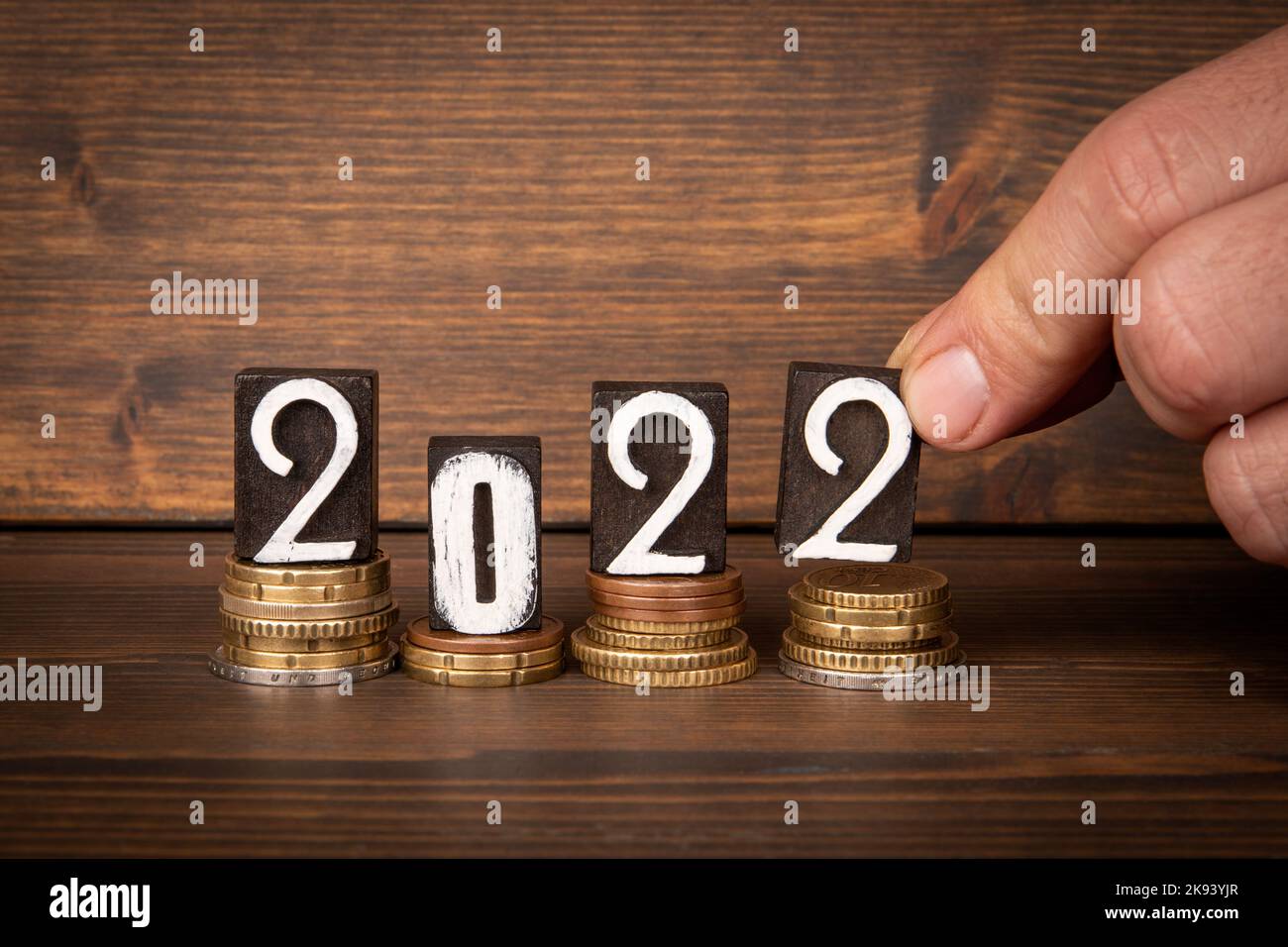 2022 Review concept. Change and wooden blocks on wood texture background. Stock Photo