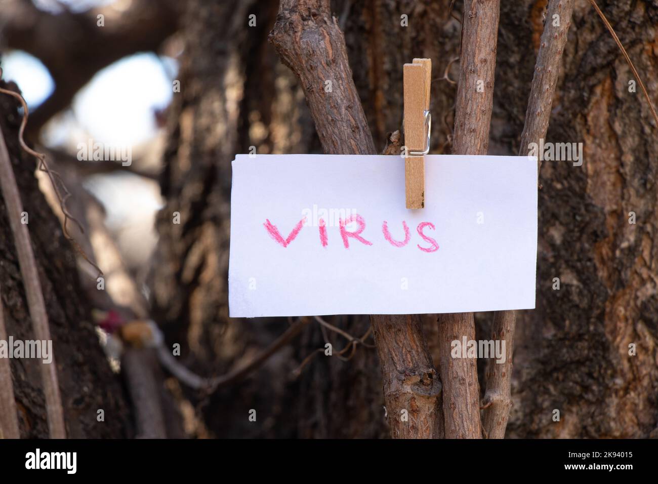 The viral word in English is written in red on a white sheet. It weighs