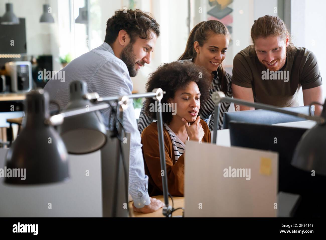 Diverse group of professionals meeting in office. IT programmers use ...