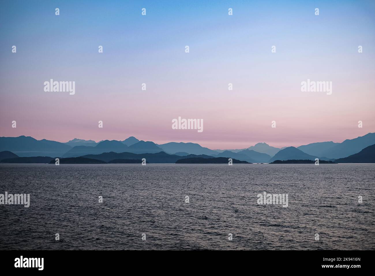 Early morning in the ocean and mountains near Vancouver Island. Beautiful sunrise. Dawn over the sea and mountains. Nobody, travel photo, copy space f Stock Photo