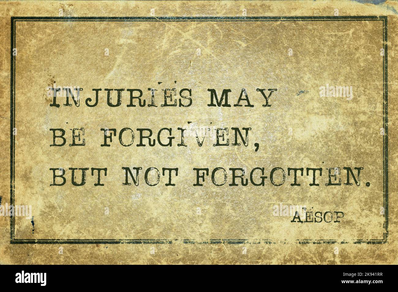Injuries may be forgiven, but not forgotten - famous ancient Greek story teller Aesop quote printed on grunge vintage cardboard Stock Photo