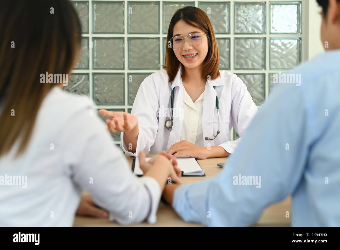 Gynecologist consultation with married couple during appointment at clinic. Family planning