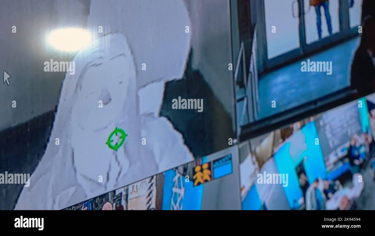 Security system monitor with multiple camera views. People from ...