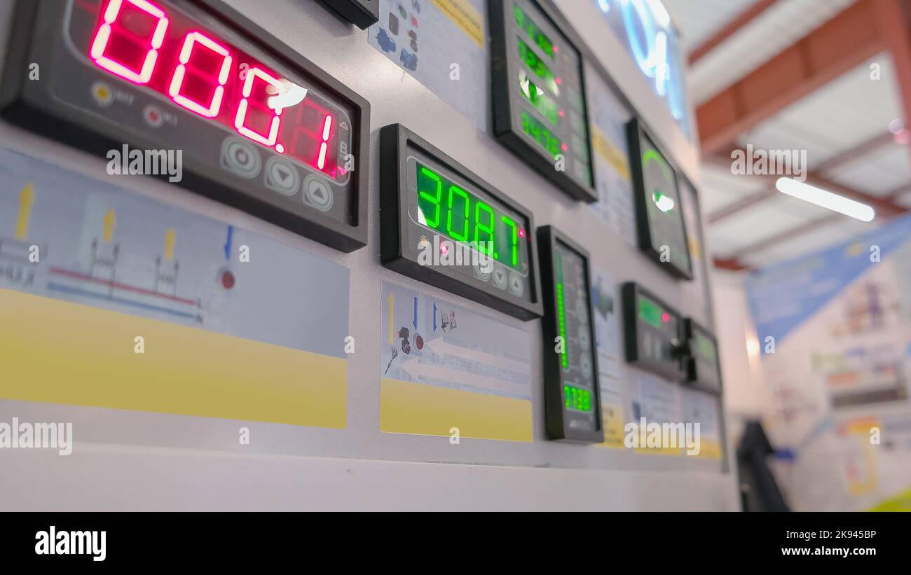 Metal panel with red and green digital indicators. Number displays