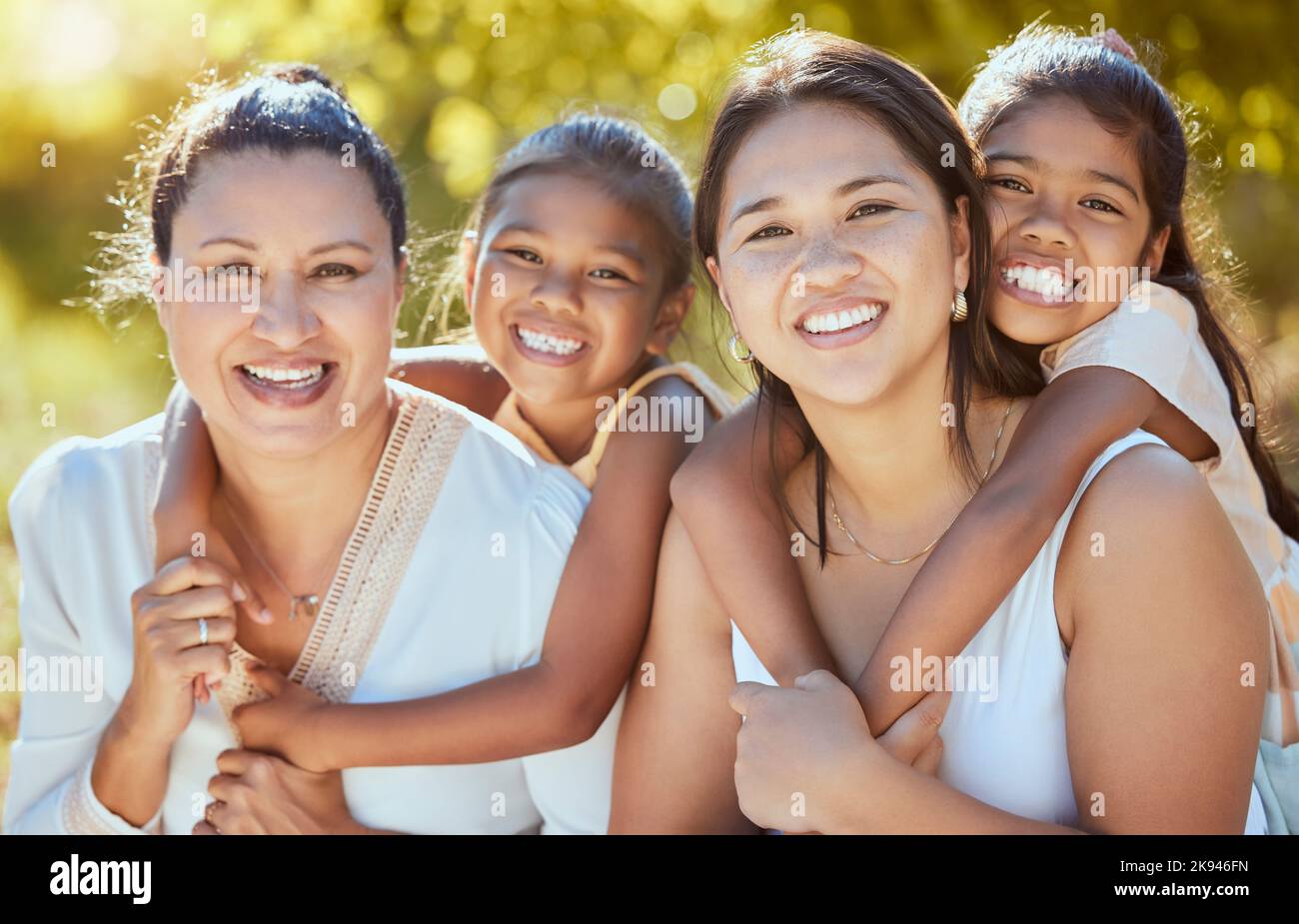 Family, portrait and women relax in a park, bonding with children, mother and grandmother in nature. Love, happy family and kids hug, smile and Stock Photo