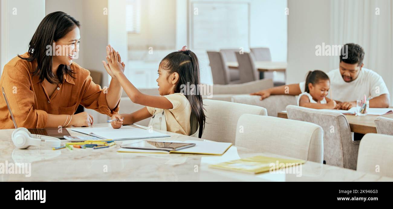 High five, homework and parents with support for children, motivation and goal in education in their house. Happy, excited and girl learning, studying Stock Photo