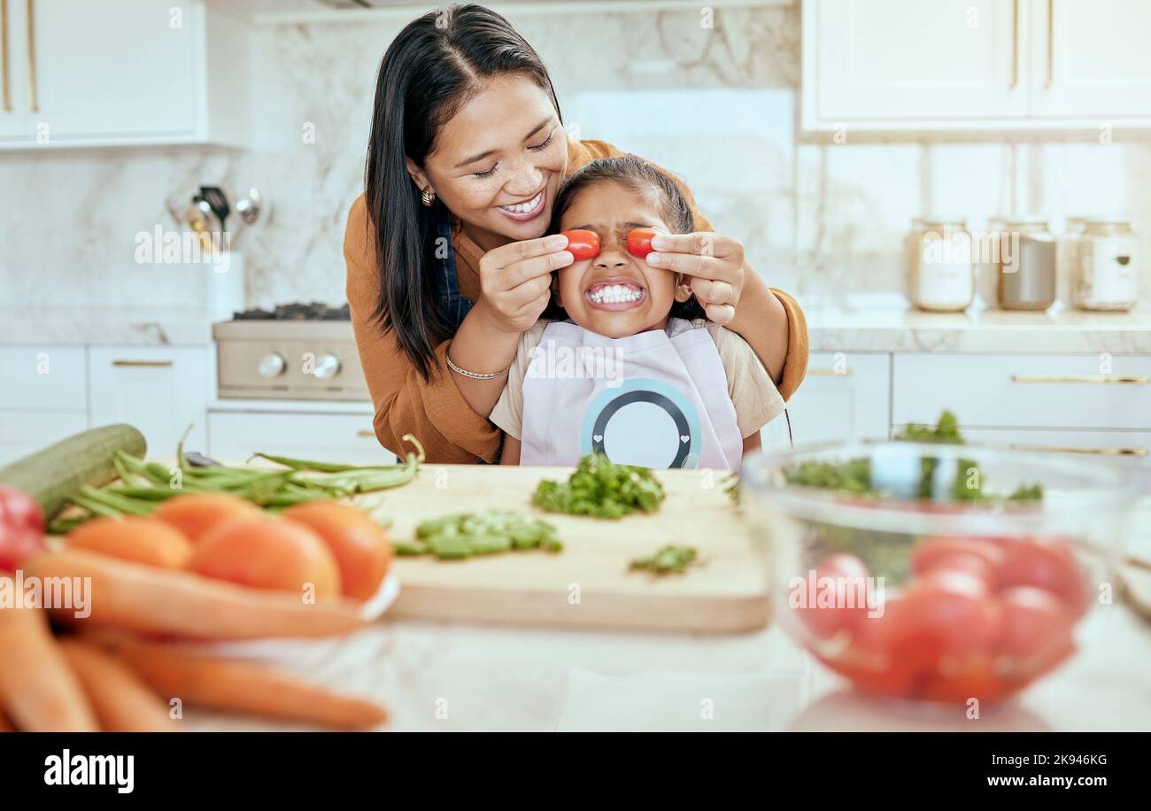 Mother cooking dinner on kitchen with her little cute kid Stock Photo -  Alamy