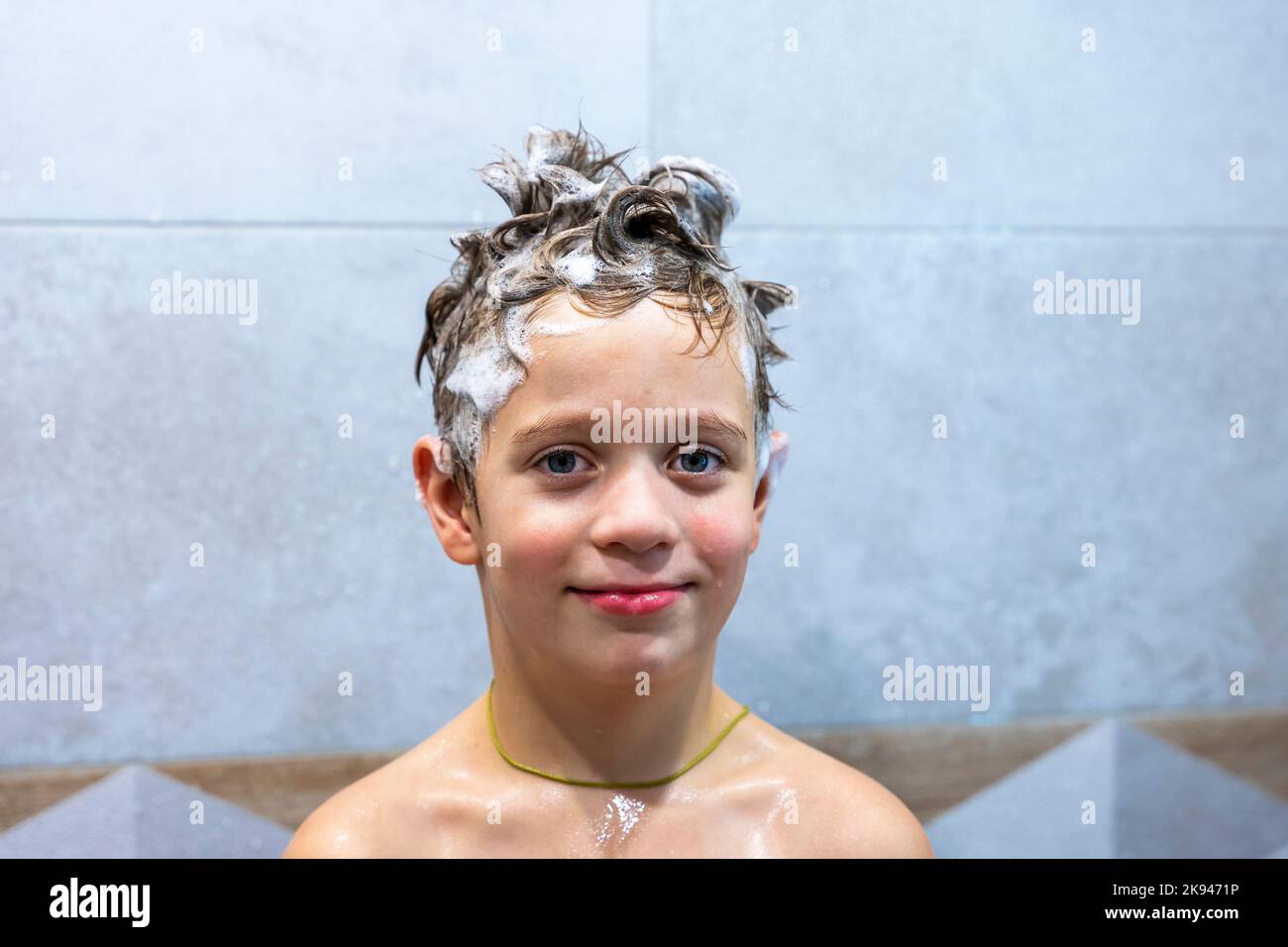 boy washes his head in the bathroom with shampoo Stock Photo Alamy