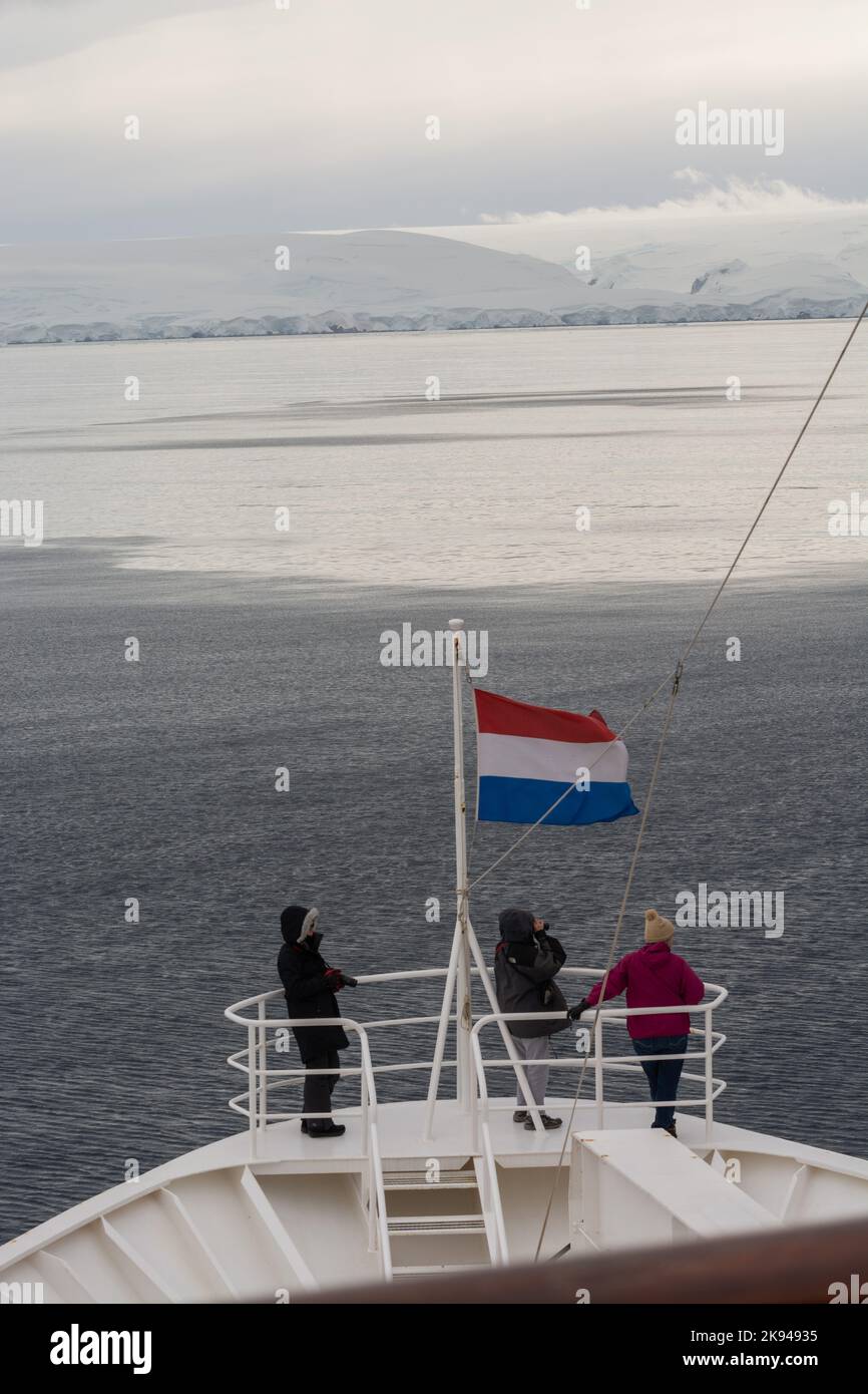 passengers on bow of HAL cruise ship 'Prinsendam' with dutch flag flying. antarctic peninsula. antarctica Stock Photo