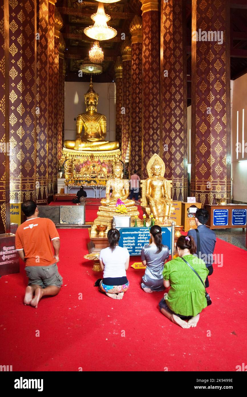 AYUTTHAYA, THAILAND - DEC 24, 2009: people worshipping in monastery Wat