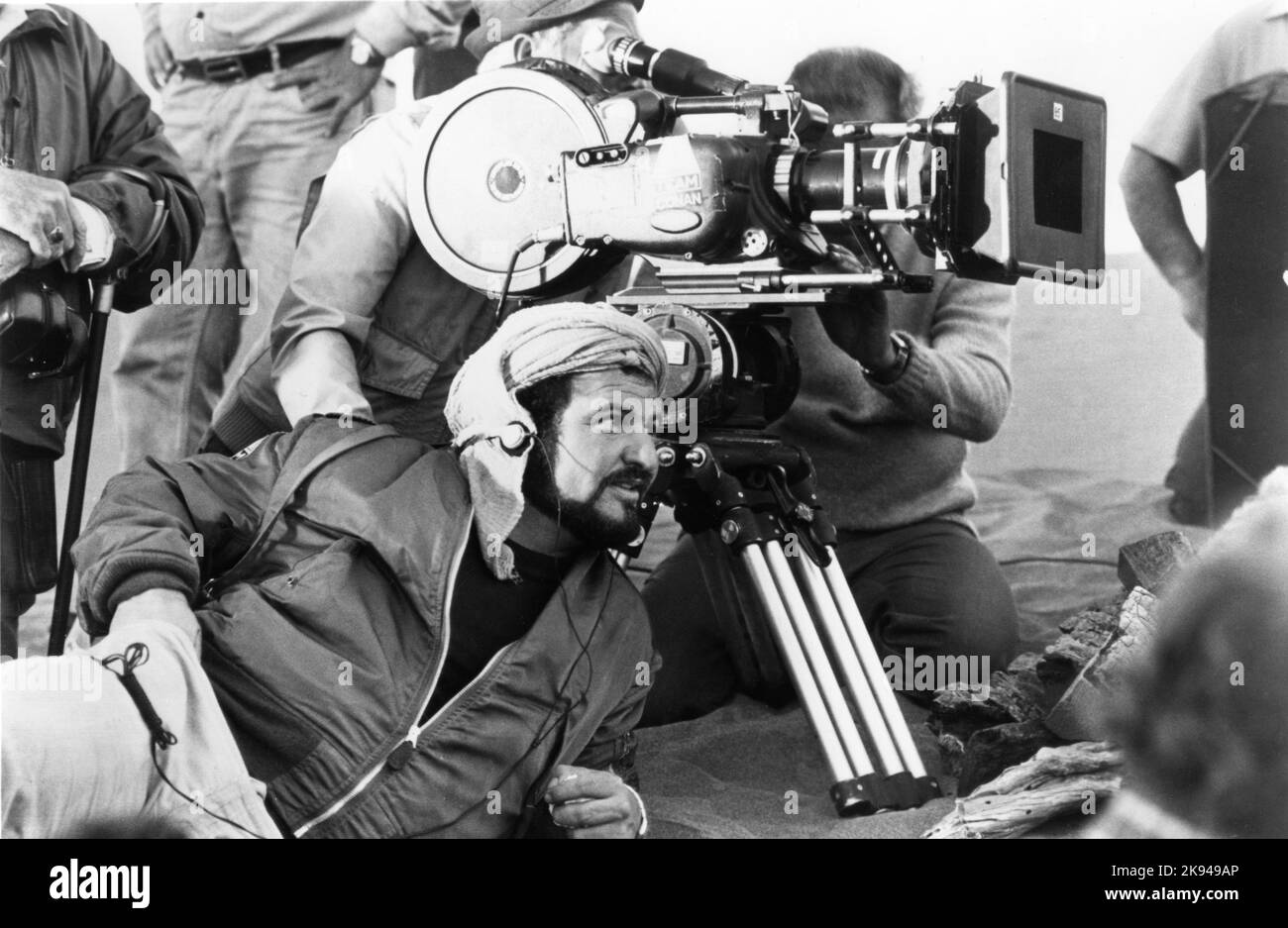Director JOHN MILIUS on set location candid with Camera / Movie Crew during location filming in Spain for ARNOLD SCHWARZENEGGER in CONAN THE BARBARIAN 1982 director JOHN MILIUS based on the character created by Robert E. Howard written by John Milius and Oliver Stone music Basil Poledouris Dino De Laurentiis Company / Pressman Film / Estudios Churubusco Azteca S.A. / A-Team / Universal Pictures Stock Photo