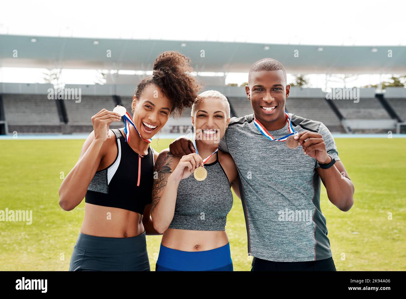 We are champions. Cropped portrait of a diverse group of athletes standing together and holding up medals after winning a running race. Stock Photo