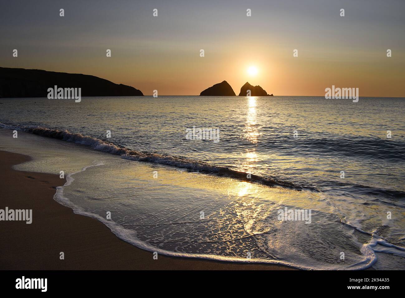 Sunset over Gull Rocks at Holywell Bay in Cornwall. Stock Photo