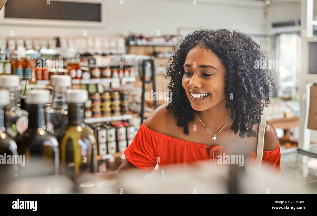 Supermarket, shopping local and sustainability, woman buying luxury food product in support of eco friendly small business. Grocery store with low Stock Photo