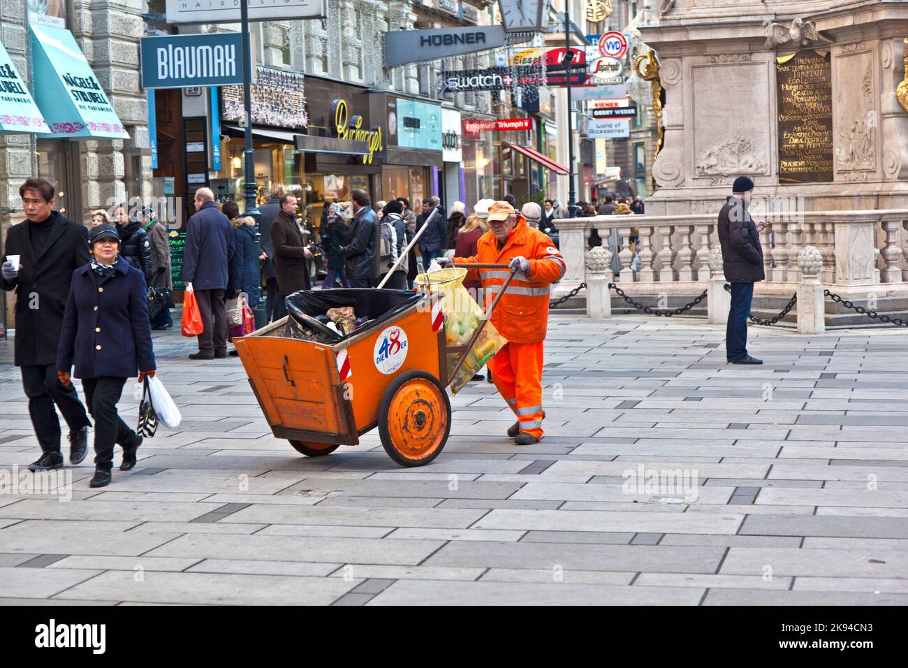 VIENNA, AUSTRIA - NOV 26: man cleaning the street at  Graben shopping area on November 26,2010 in Vienna, Austria. The Graben traces its origin back t Stock Photo