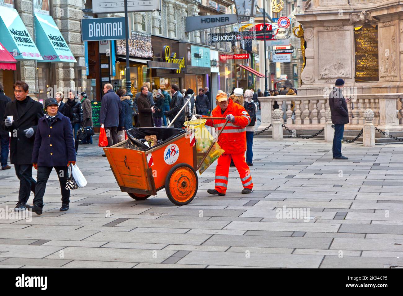 Vienna, Austria - November 27, 2010: man cleans the street at  Graben shopping area  in Vienna, Austria. The Graben traces its origin back to the old Stock Photo