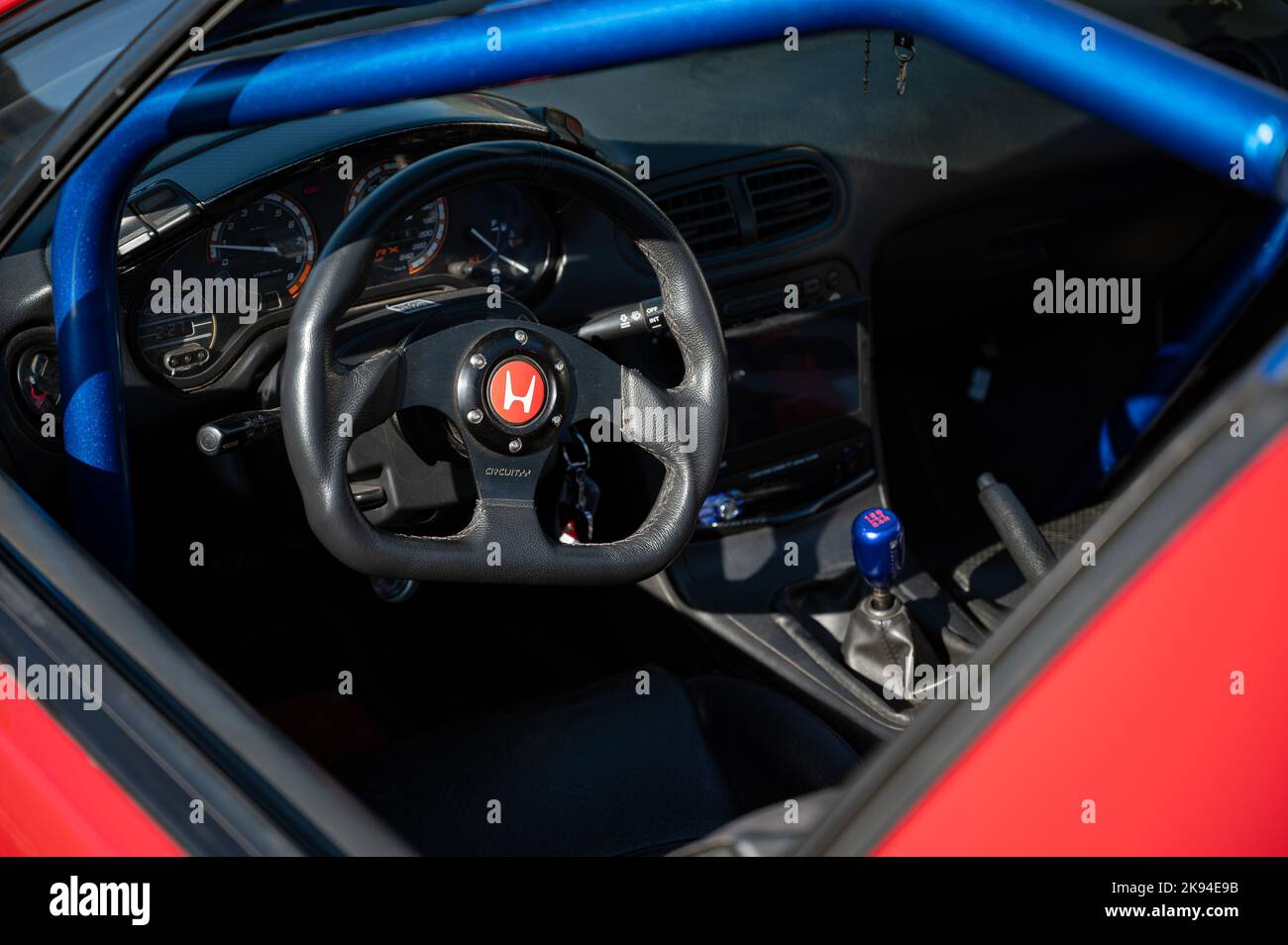The steering wheel of a tuned and improved red Honda CRX Del Sol car Stock Photo