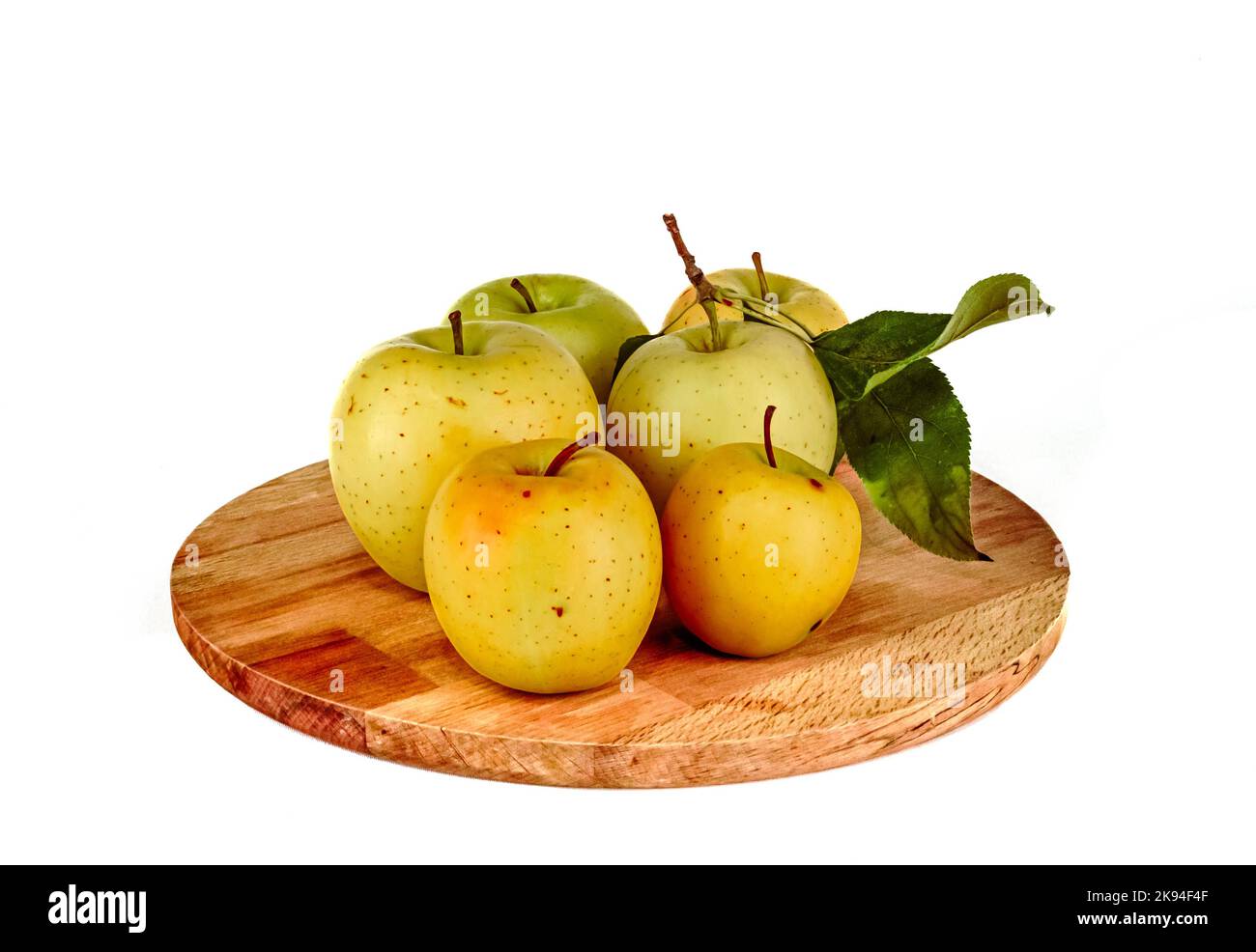 https://c8.alamy.com/comp/2K94F4F/yellow-apples-on-a-wooden-cutting-board-bunch-of-yellow-golden-apples-on-a-white-background-with-green-leaf-small-to-big-isolated-2K94F4F.jpg