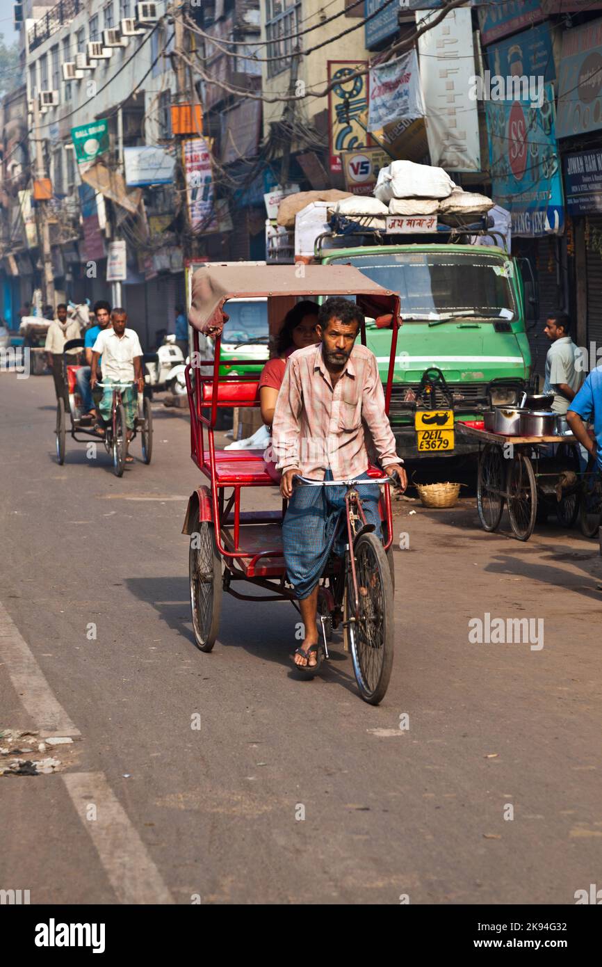 Delhi, India - November 9, 2011: Rickshaw rider transports passenger ...