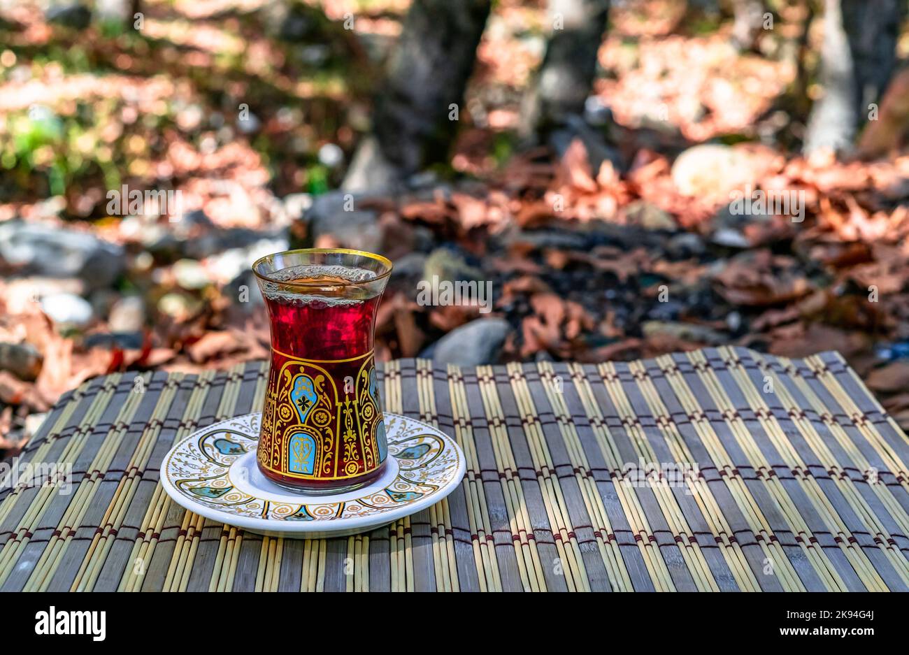 Close up turkish tea at forest picnic camping. Autumn dry leaves ...
