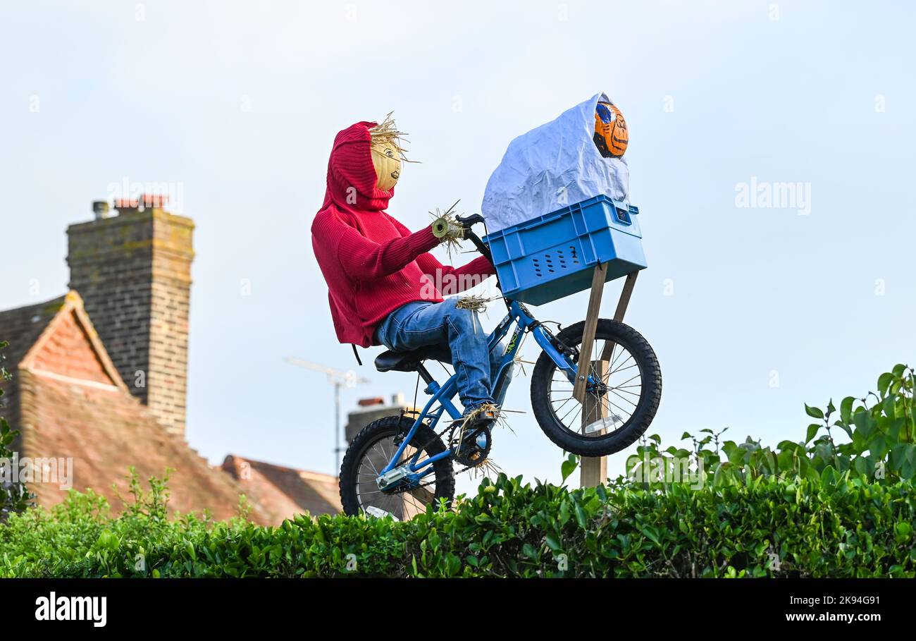 Worthing UK 26th October 2022 - ET has appeared flying over a hedge in the annual Scarecrow Festival in Ferring village near Worthing , West Sussex . Over 70 scarecrows are expected to appear throughout the village over the week : Credit Simon Dack / Alamy Live News Stock Photo
