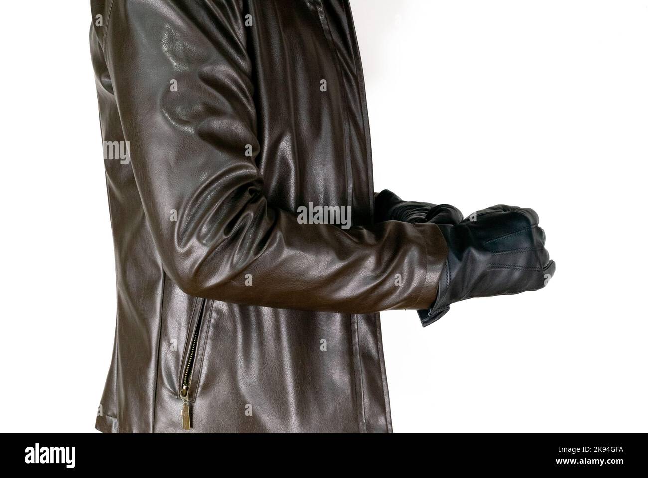 Men brown jacket and leather glove on white background. Spring stylish man wear brown leather jacket and fist hand with glove. Stock Photo