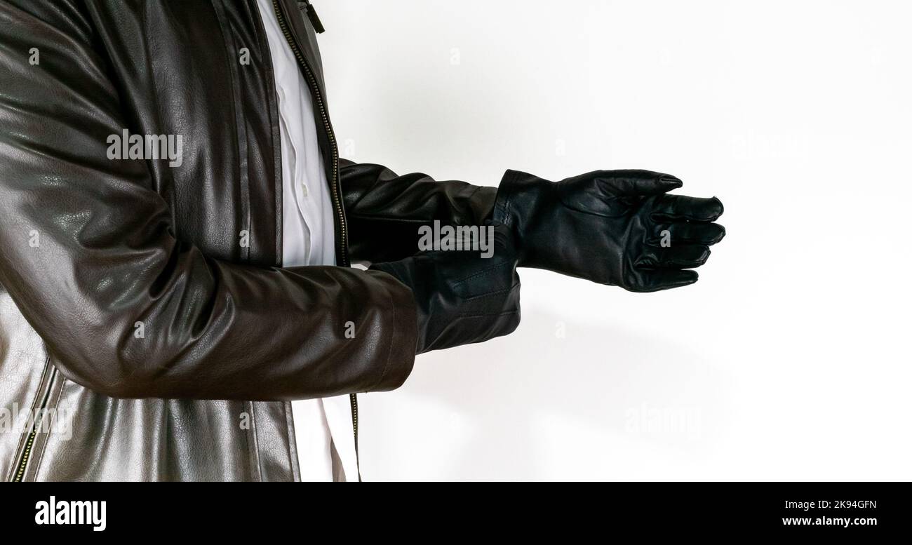 Men wearing leather glove on white background. Man with brown leather jacket wear glove isolated. Nobody and no face. Stock Photo