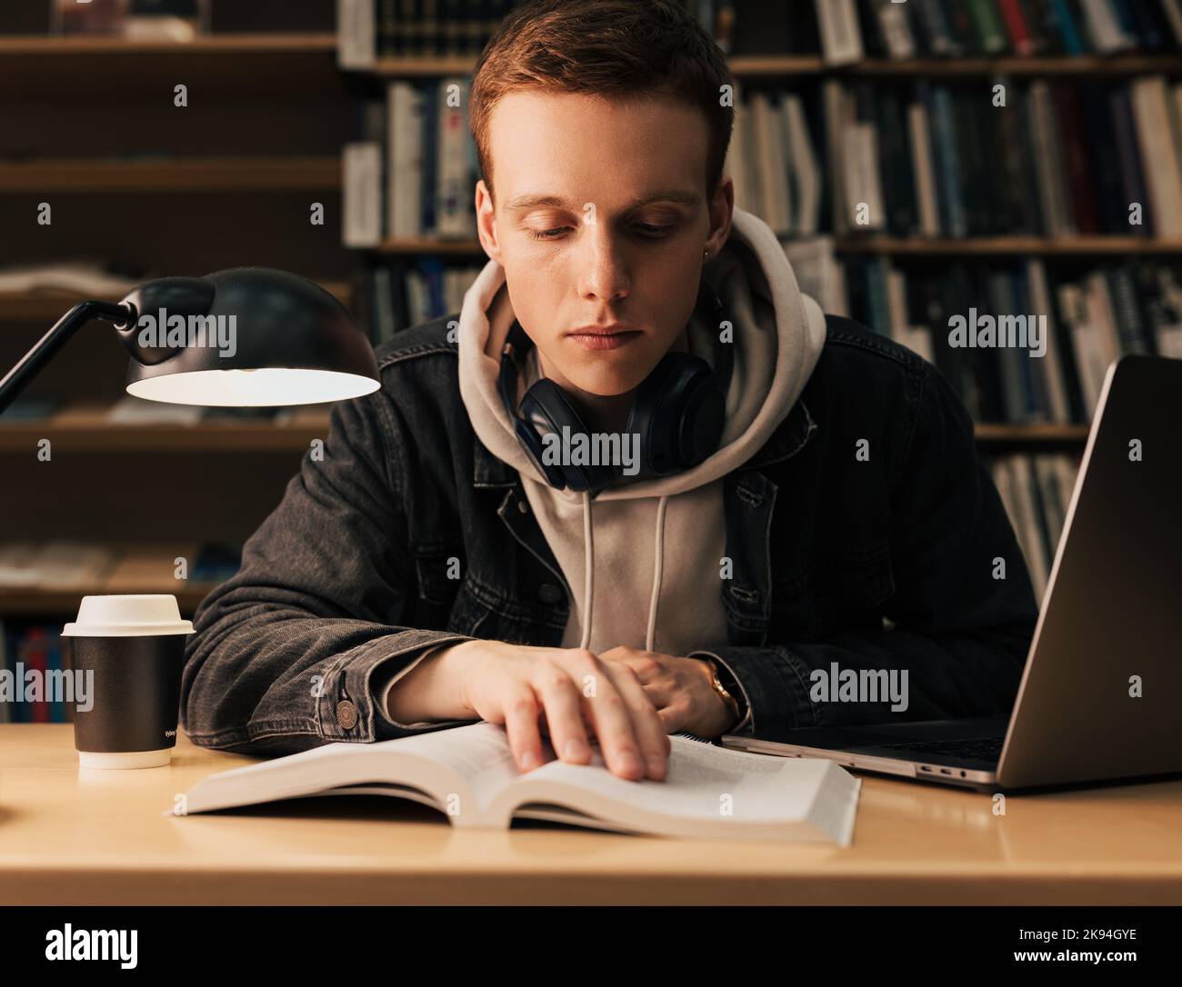 Reader Guy Male student reading from a book. Guy with headphones preparing his ...