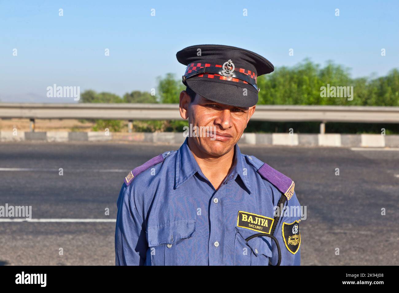 JAIPUR, INDIA - NOV 12: A private guardin uniform protects the parking place and the restaurant at the highway Delhi - JAIPUT on November 11,2011 in D Stock Photo