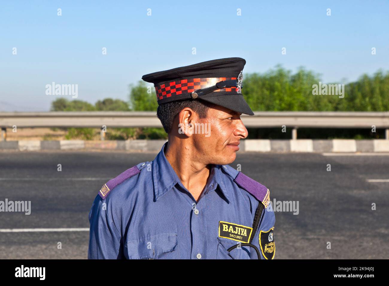 JAIPUR, INDIA - NOV 12: A private guardin uniform protects the parking place and the restaurant at the highway Delhi - JAIPUT on November 11,2011 in D Stock Photo