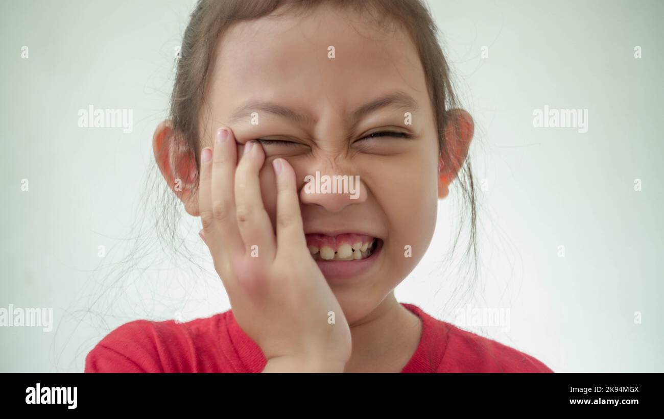 Upset charming six years old girl suffering from teething ache Stock
