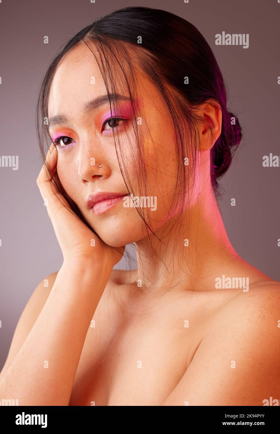 Futuristic, asian and makeup of woman for beauty, cosmetics and skincare color in studio mock up and neon light. Skin care, future and vaporwave model Stock Photo