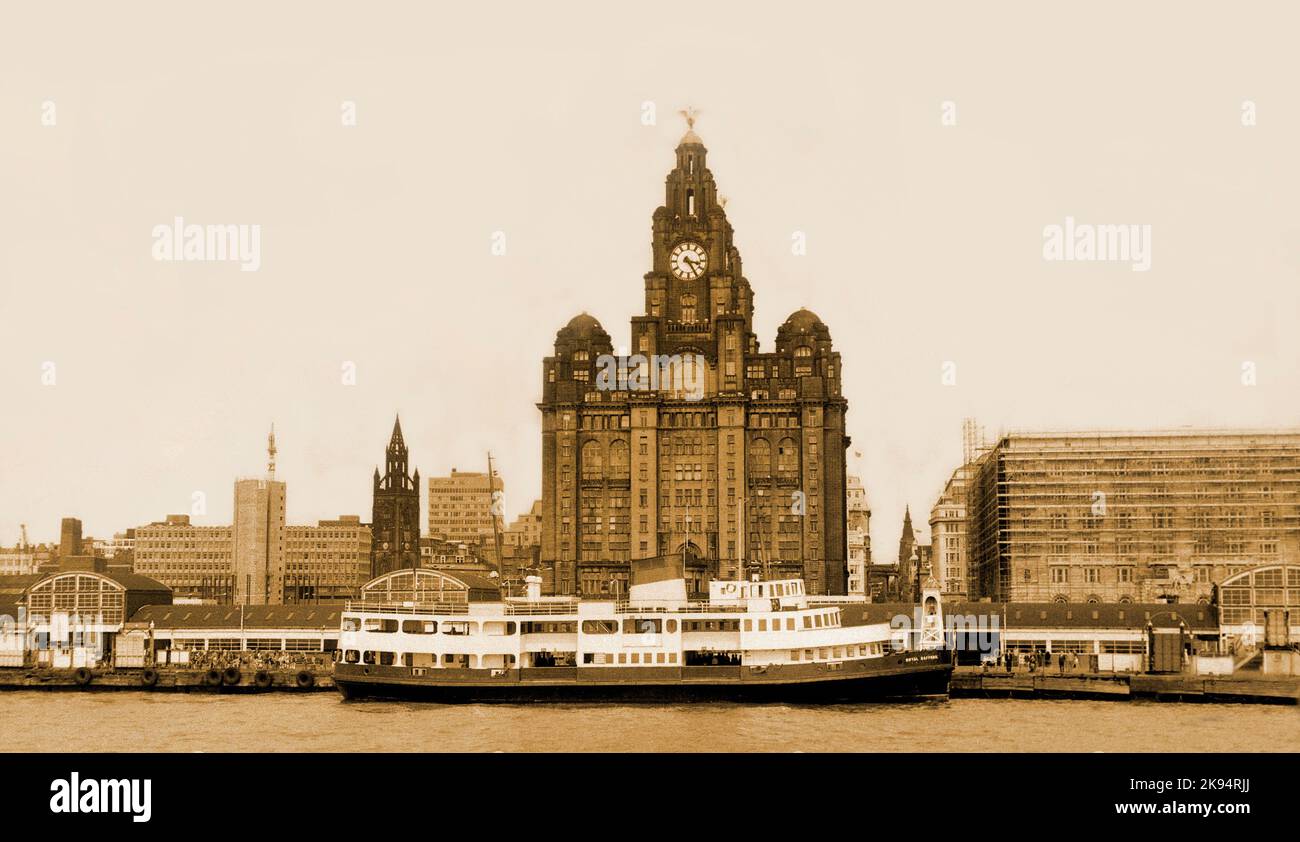 Vintage Liverpool waterfront c.1968, the pier head, the Royal Liver buildings (before later cleaning) a ferry boat is docked at the Pier Head. Stock Photo