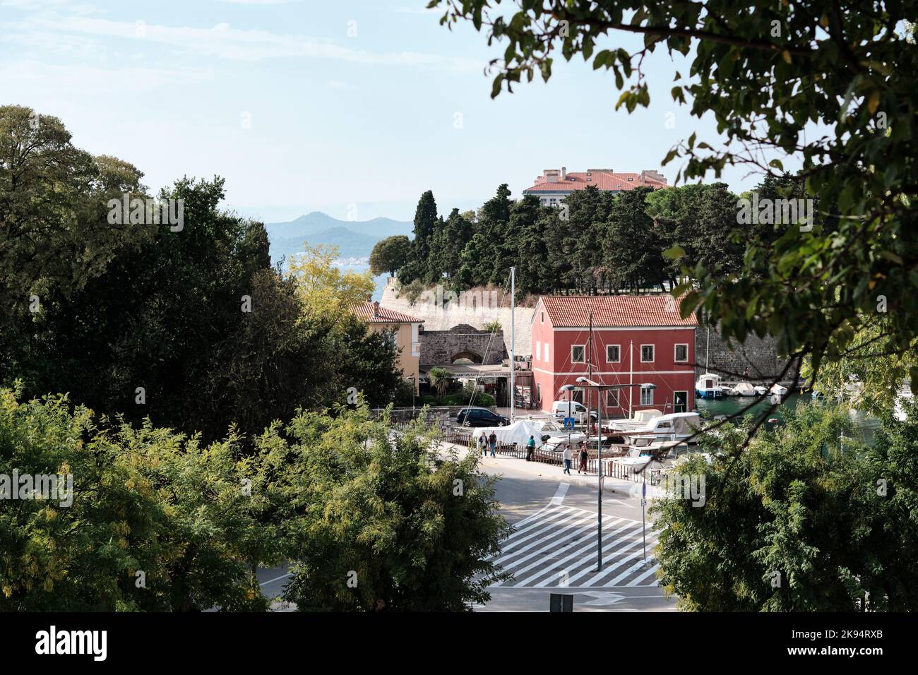Fosa harbour by the Venetian Land gate in the city walls of Old Zadar, Croatia housing the Fosa seafood restaurant from on top of the medeval walls Stock Photo