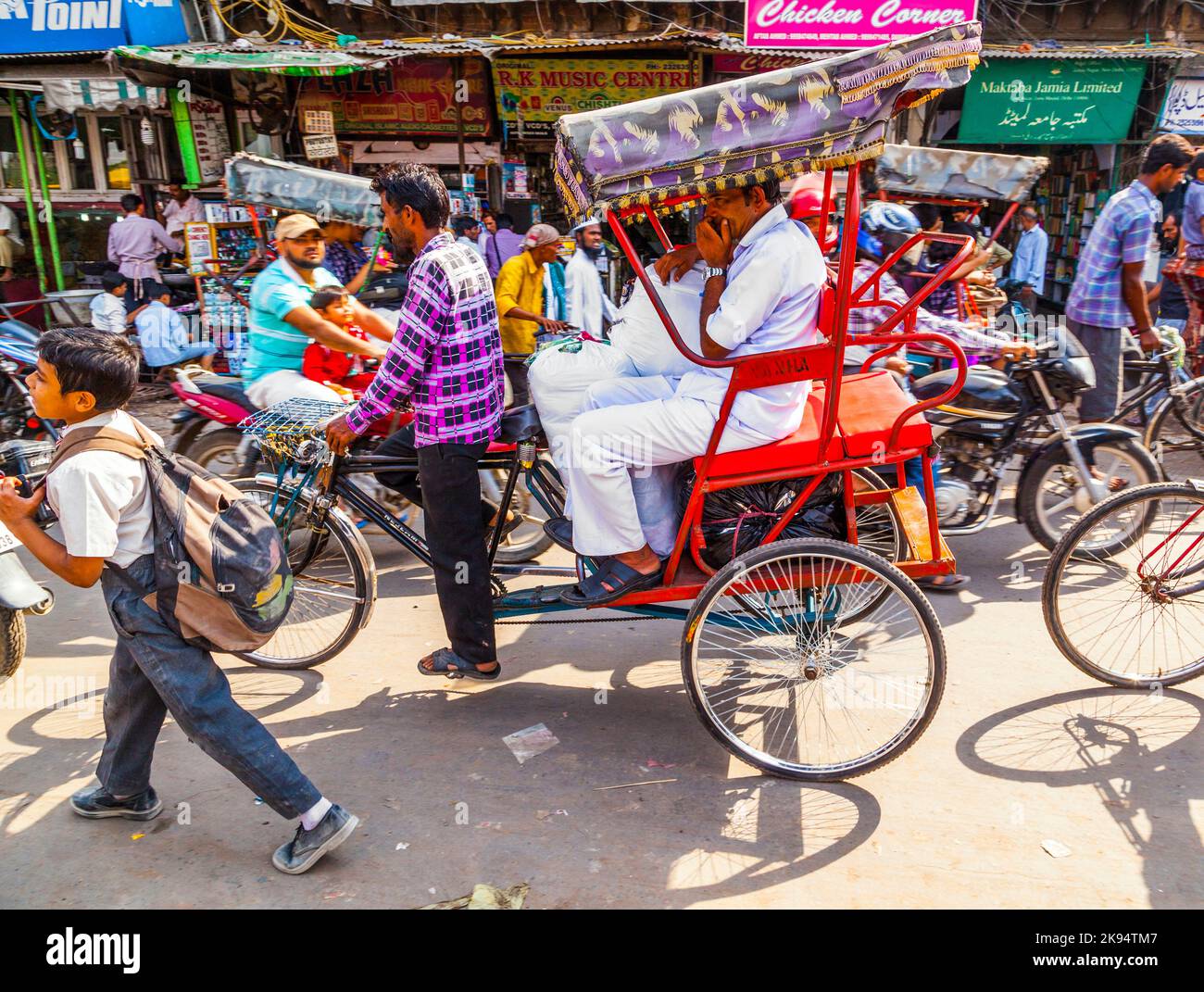 DELHI, INDIA - OCT 10: Rickshaw rider transports passenger on October ...
