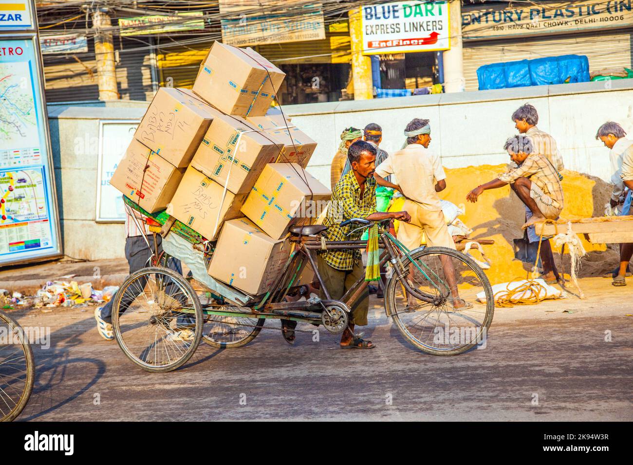 DELHI, INDIA - OCT 16: Rickshaw rider transports heavy goods early ...