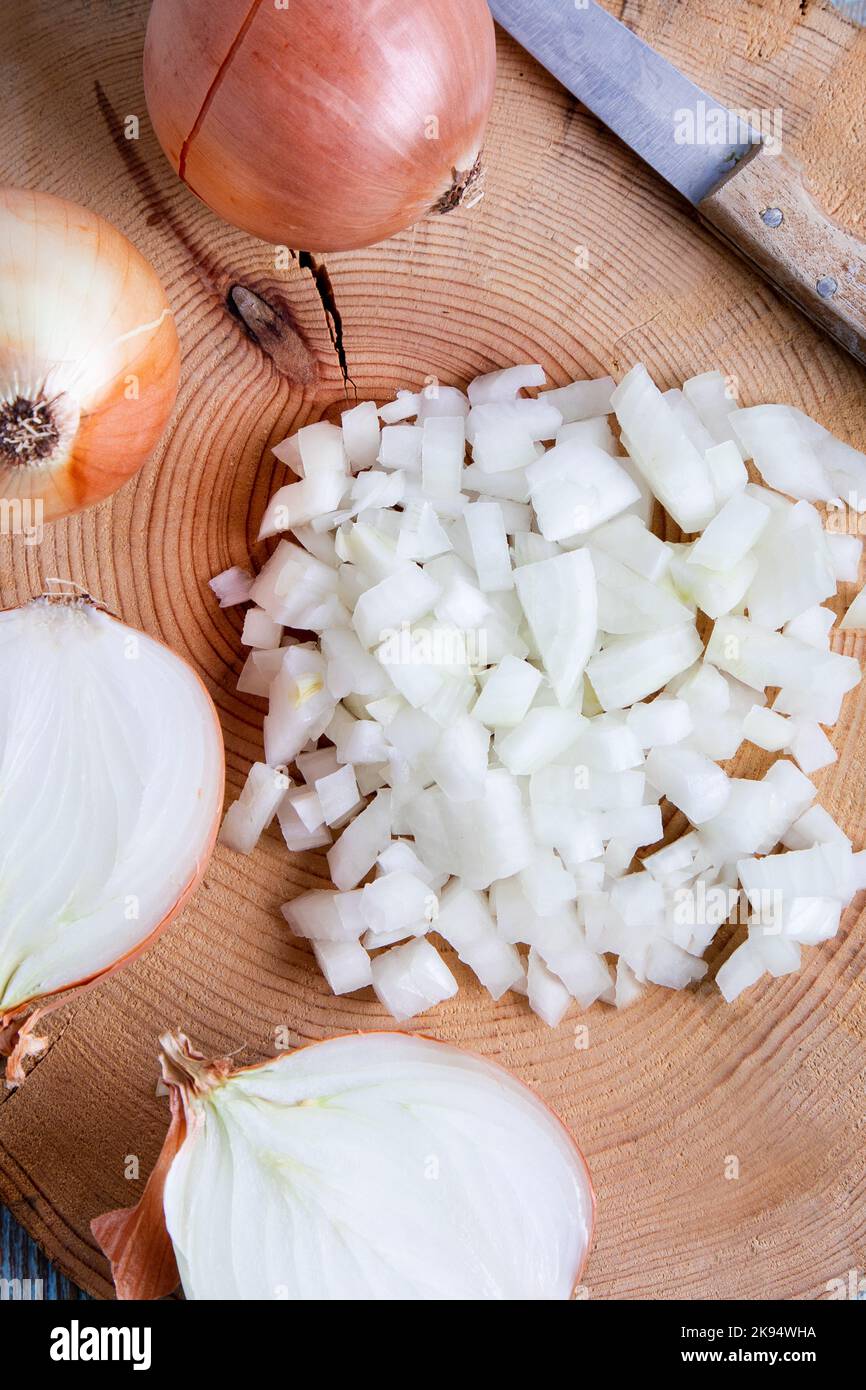 onions cut in half and chopped on old wooden board Stock Photo - Alamy