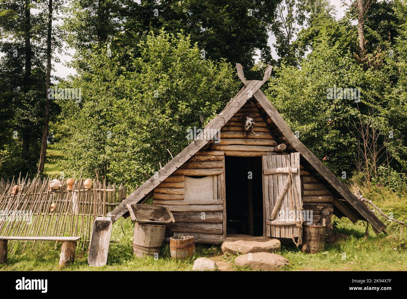 Triangular Logentry Triangular log houses with wooden roofs behind a fence. Montenegro ...