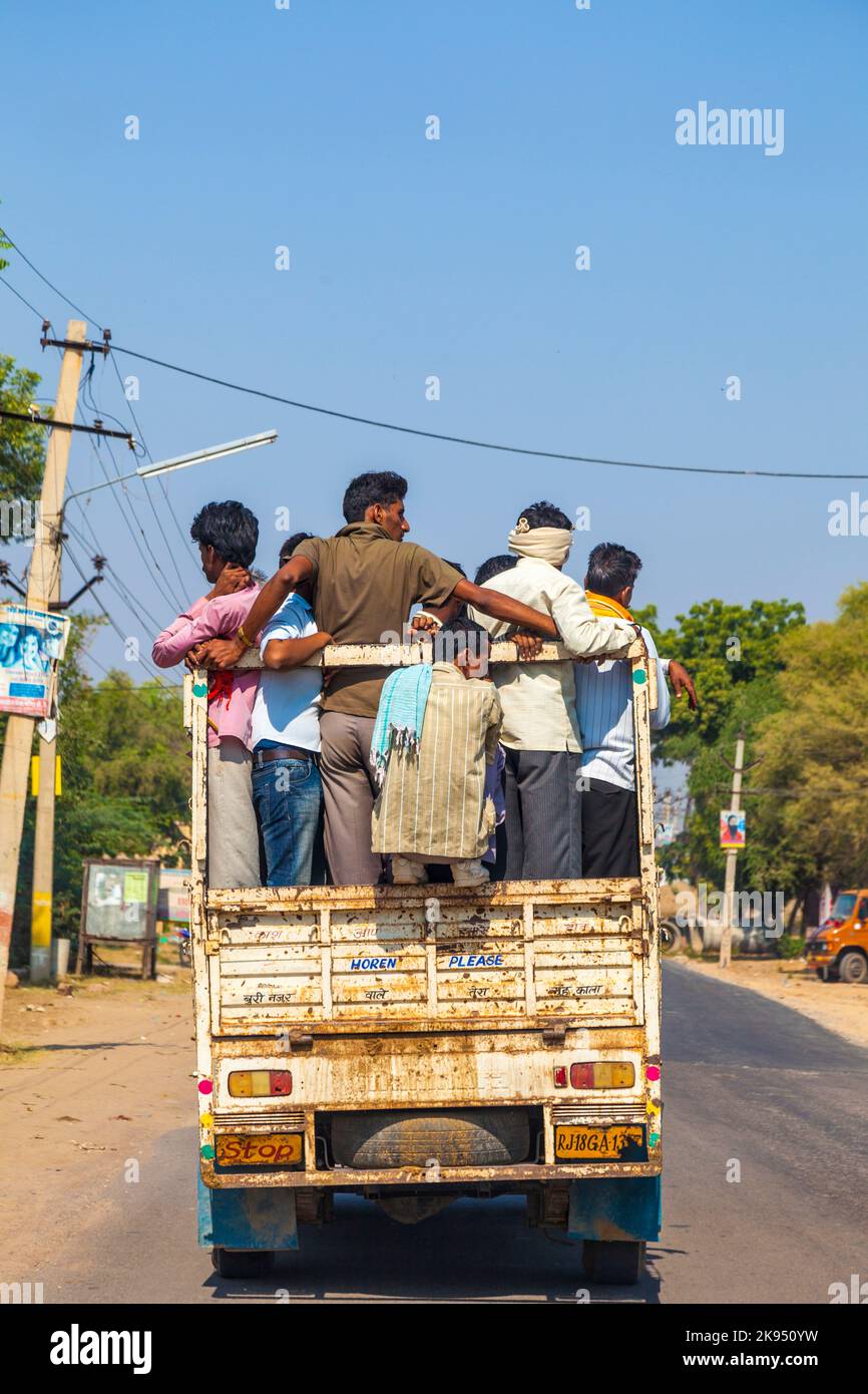 Daola, India - October 25, 2012:people on highway 71 in overloaded truck in Daoloa, India. Overload ist the most dangerous reason for car accidents. Stock Photo